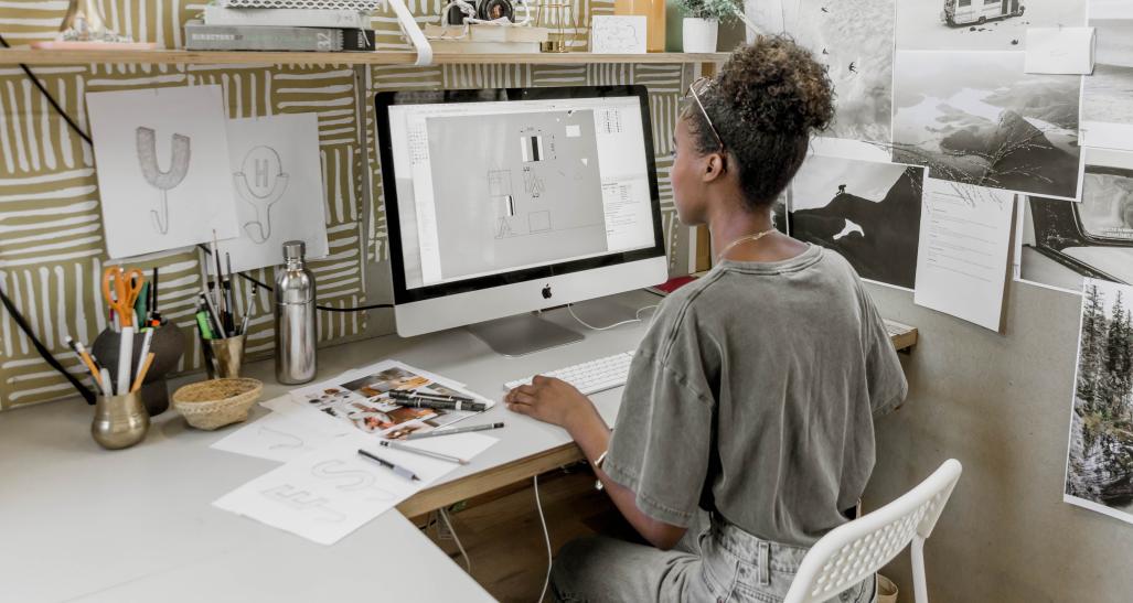 Intern working at computer at desk